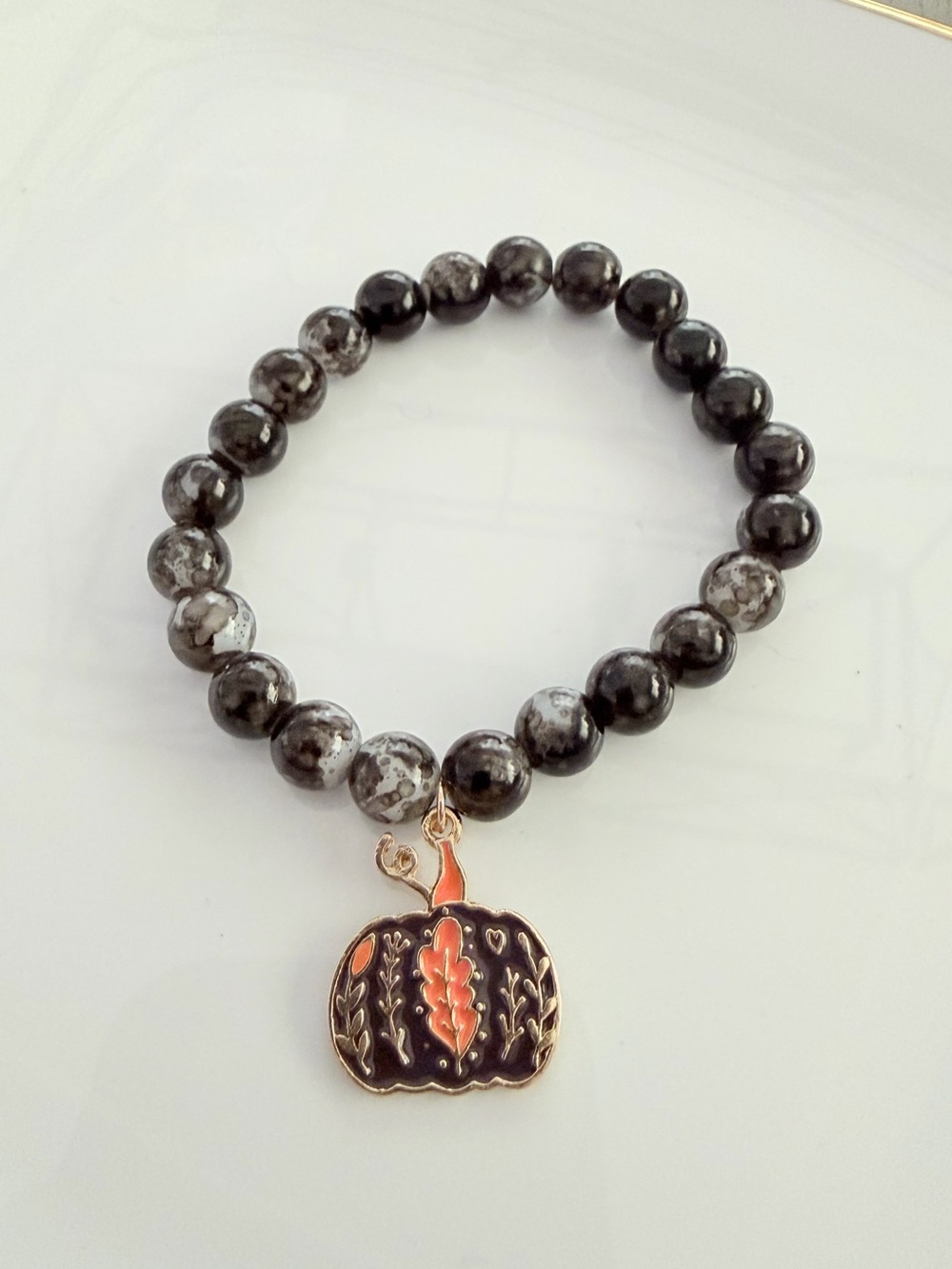 Black and Gray Beaded Bracelet with Orange Pumpkin Charm